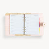 Open blush A5 vegan leather planner with, gold lining and goal pages, and a gold clasp on the front cover.
