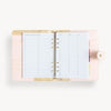 Open blush A5 vegan leather planner with, gold lining and things to do pages, and a gold clasp on the front cover.