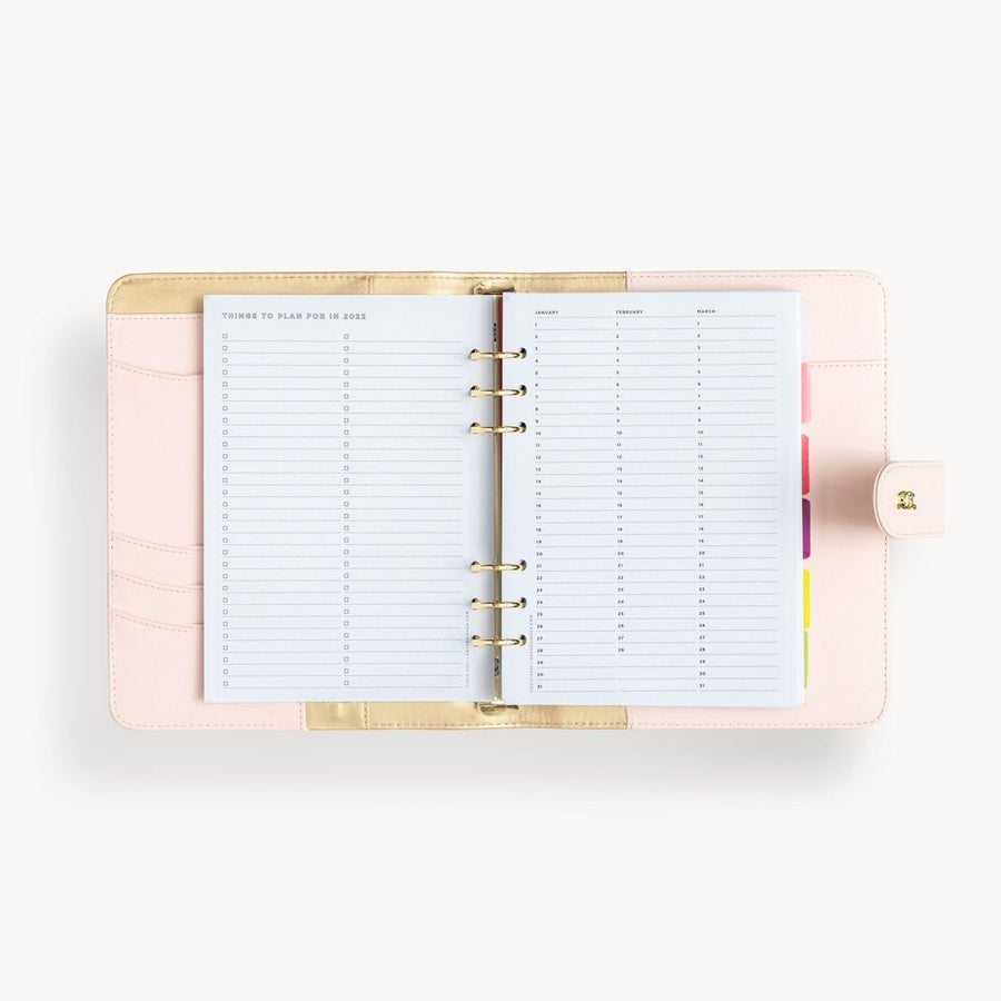 Open blush A5 vegan leather planner with, gold lining and things to do pages, and a gold clasp on the front cover.