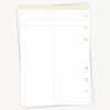 White planner refill sheet with button holes on a white background