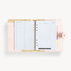 Open blush A5 vegan leather planner with, gold lining and big to do pages, and a gold clasp on the front cover.
