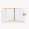 Open blush A5 vegan leather planner with, gold lining and today pages, and a gold clasp on the front cover.