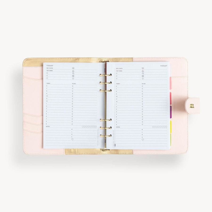 Open blush A5 vegan leather planner with, gold lining and today pages, and a gold clasp on the front cover.