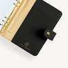 Open black A5 binder to show black and gold lining and binding
