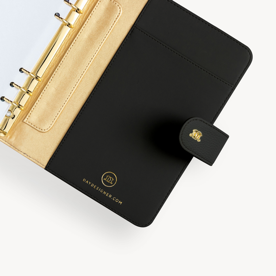Open black A5 binder to show black and gold lining and binding